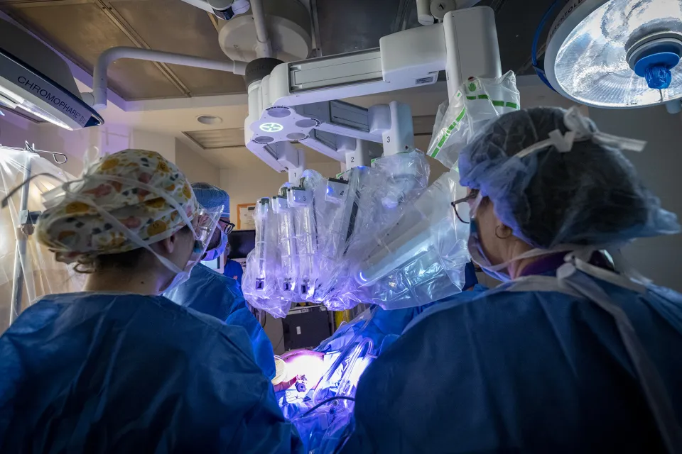 Surgeon and nurses using the new surgical robot
