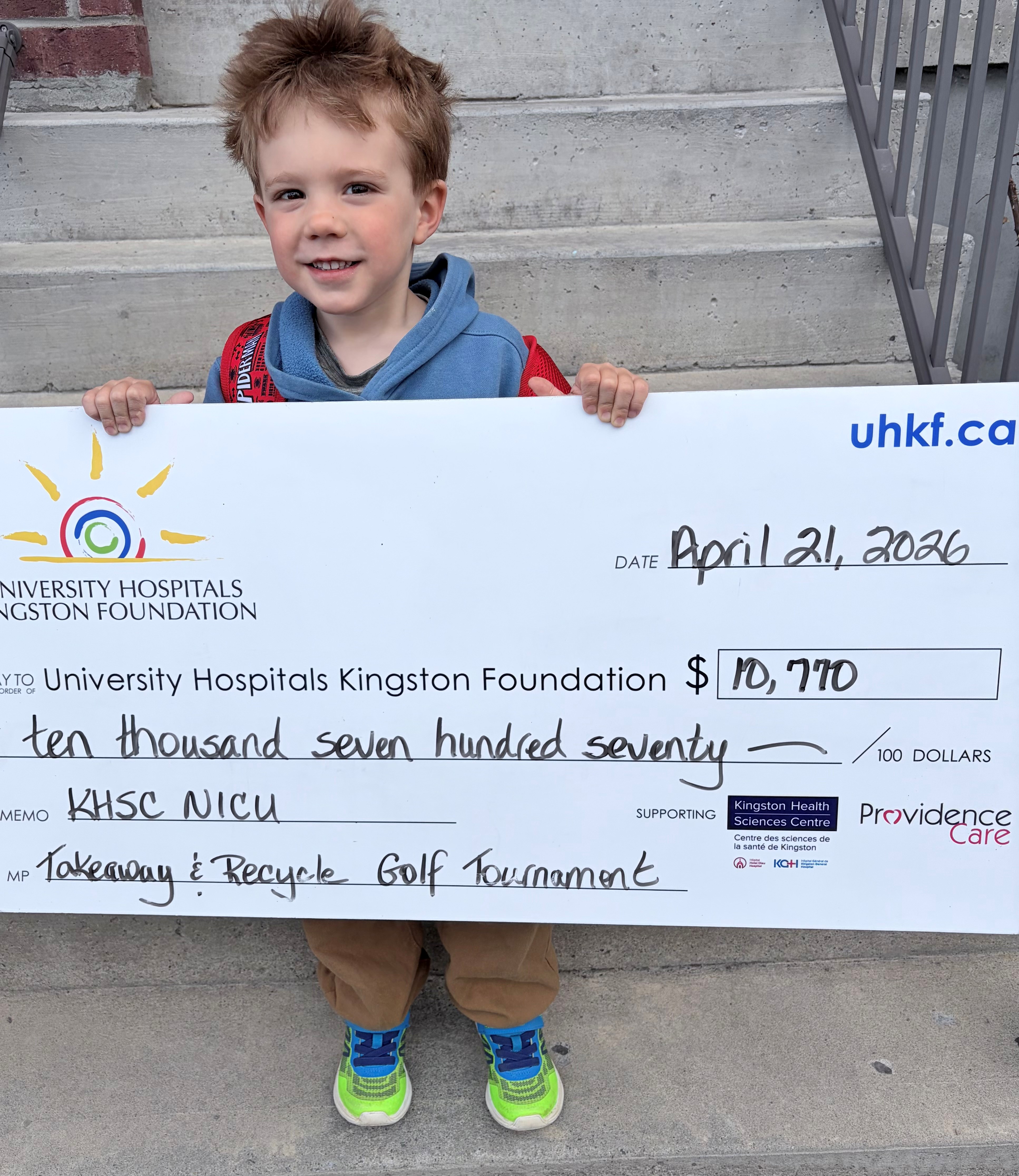 Cale Cook holding cheque.