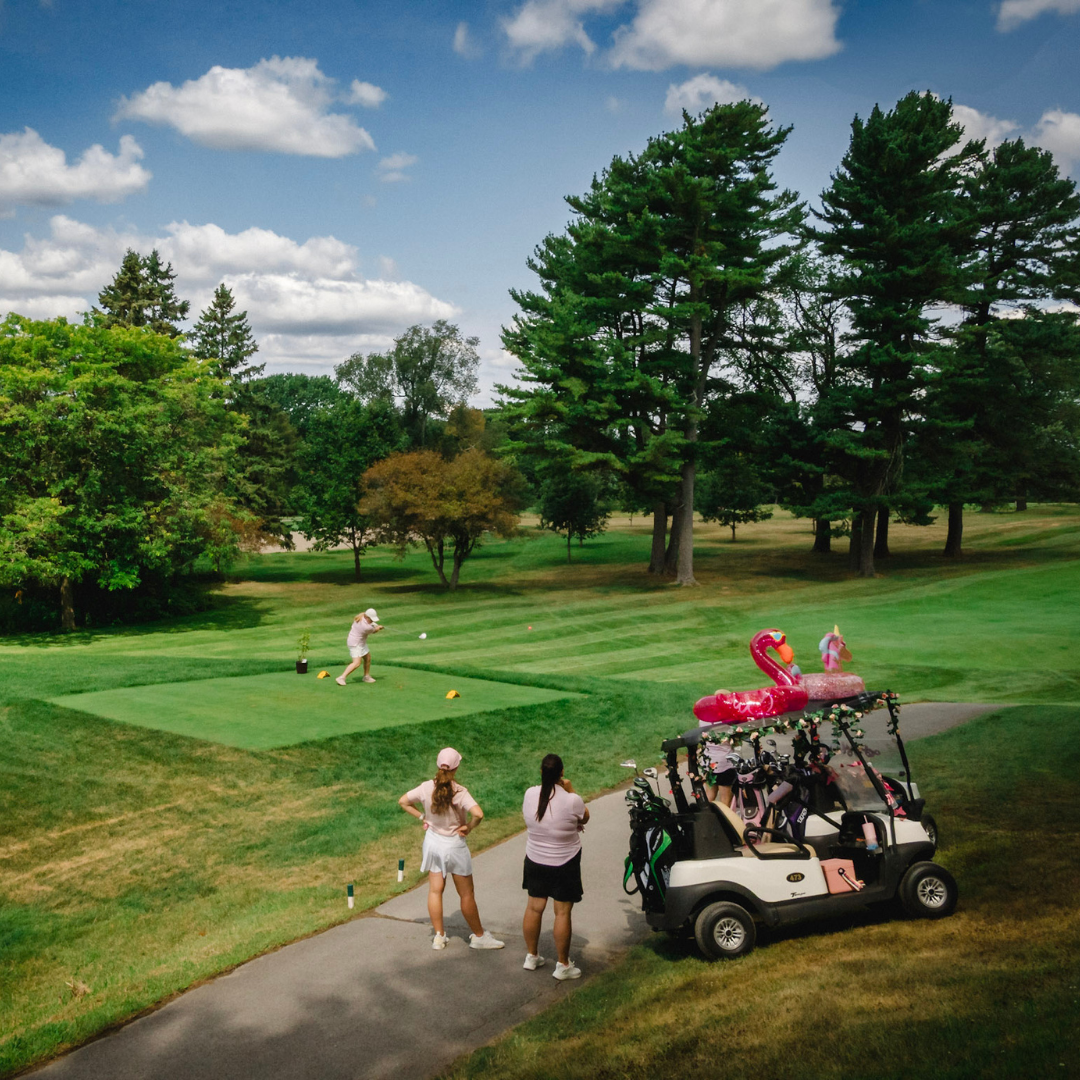 Golf car with a flamingo inflatable on the green