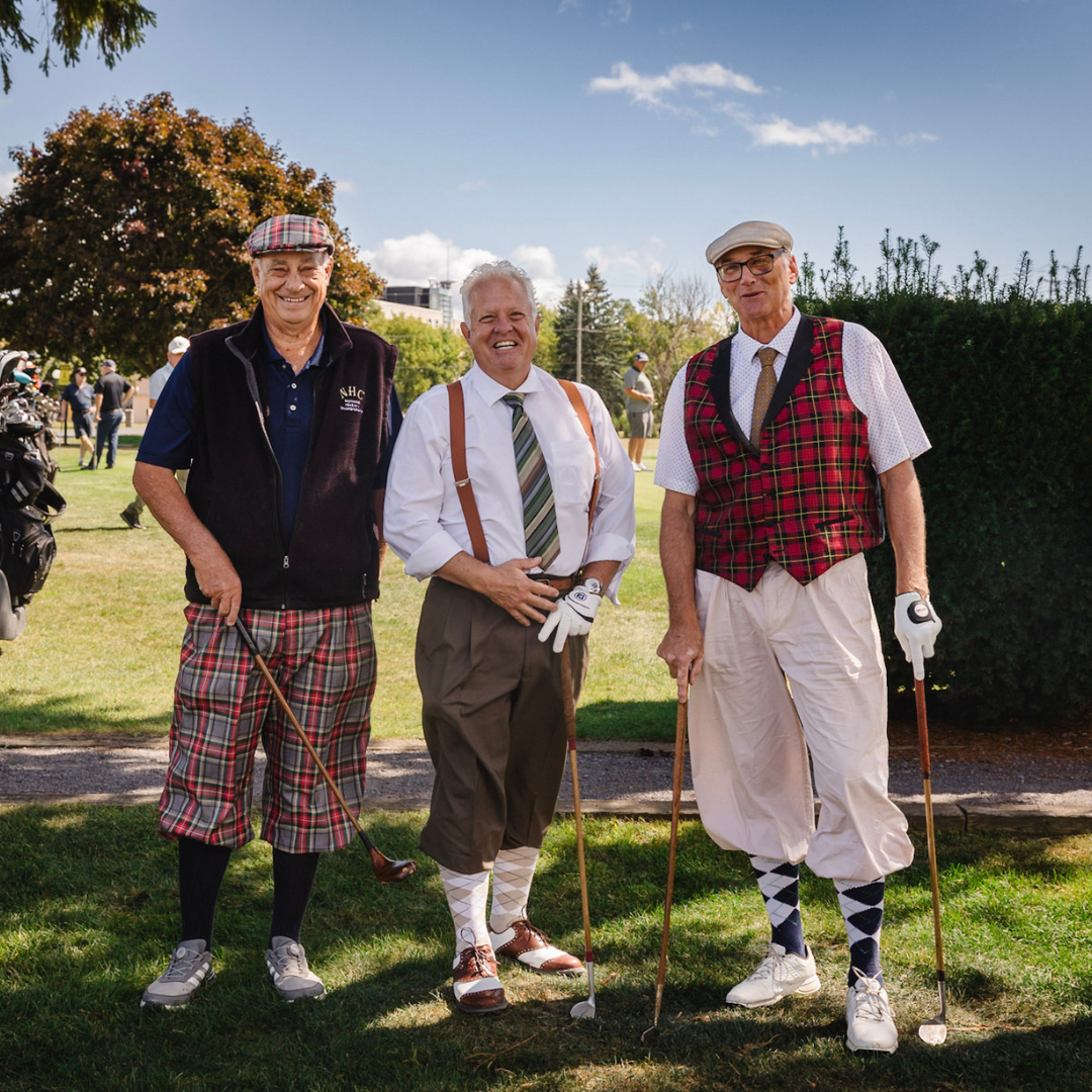 Golfers wearing traditional outfits.