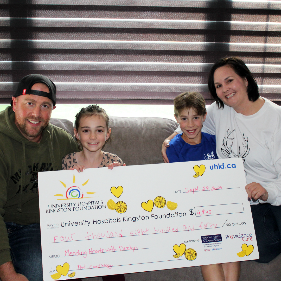 Image of the Carman family holding their 2024 proceeds cheque.