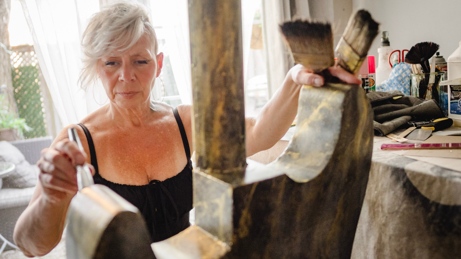 Cher Reynolds creating the guitar in her home art studio.