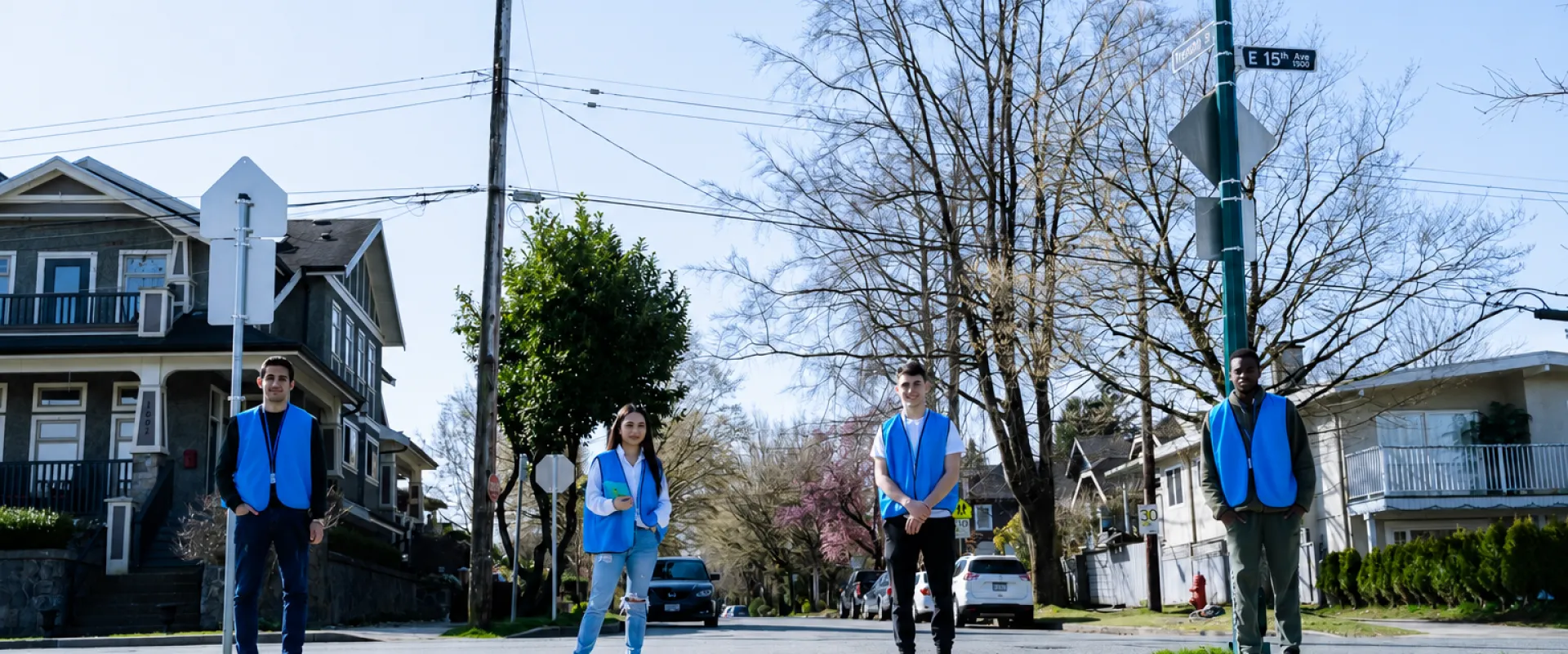 GlobalFaces canvassers in blue vests standing outside.