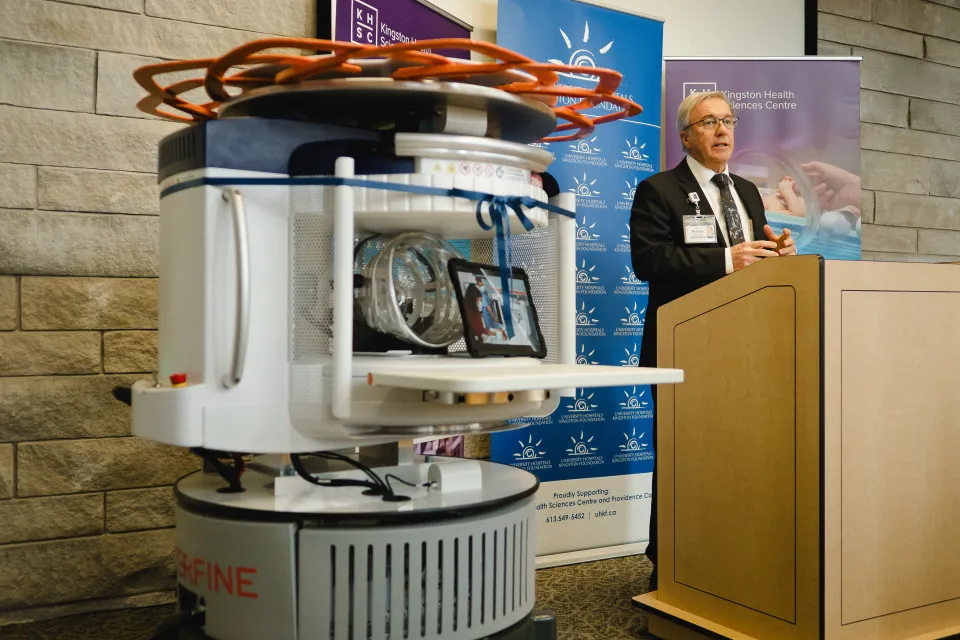 Dr. David Pichora standing next to the new portable MRI