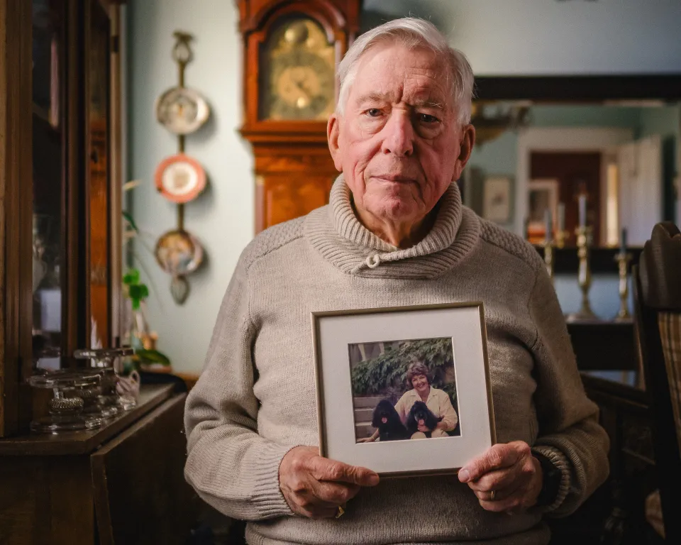 Dickson Mansfield holding a photo of his late wife Barbara