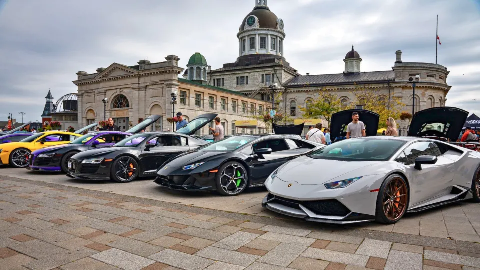 Exotic cars lined up in front of Kingston City Hall.