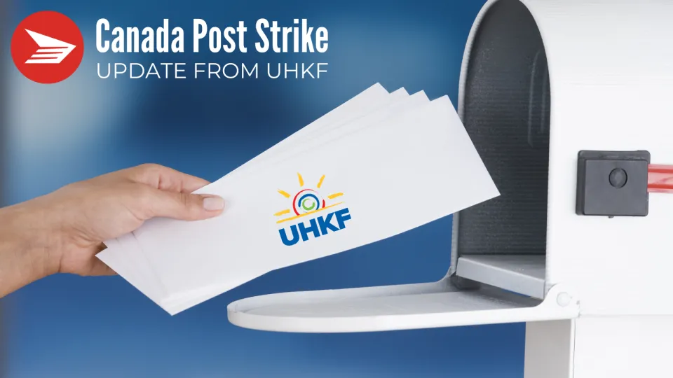 Image of a hand putting mail in the mailbox with a UHKF logo on the envelope.