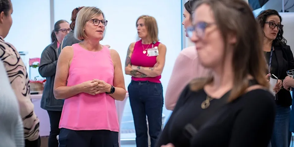 Dr. Doris Jabs smiling while wearing a pink t-shirt.