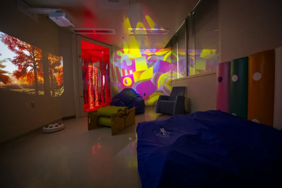 Image of the new multi-sensory room at Kingston Health Sciences Centre with calming lights and comfortable seating.