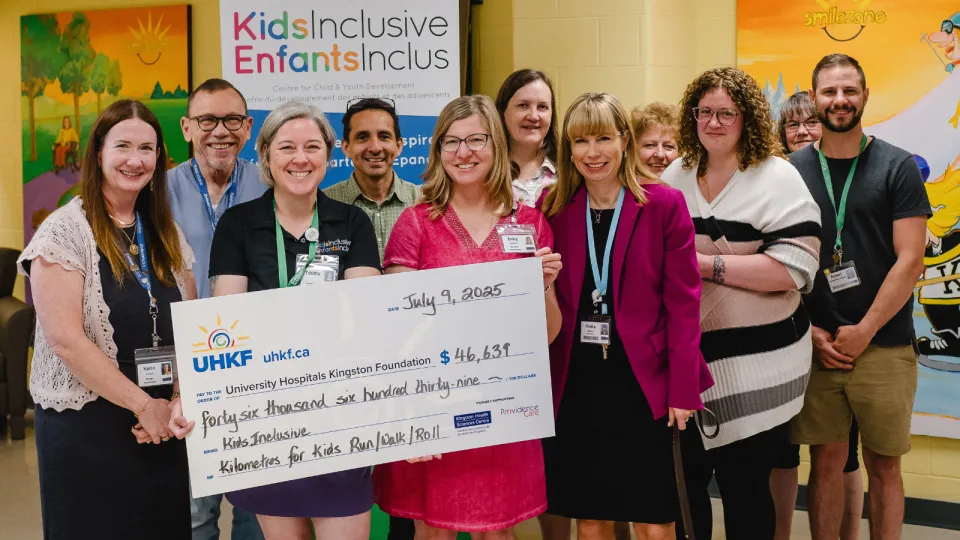 KidsInclusive staff holding big cheque
