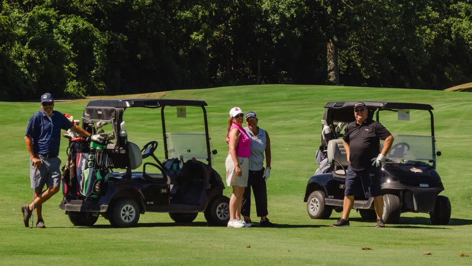 Team smiling on the course.
