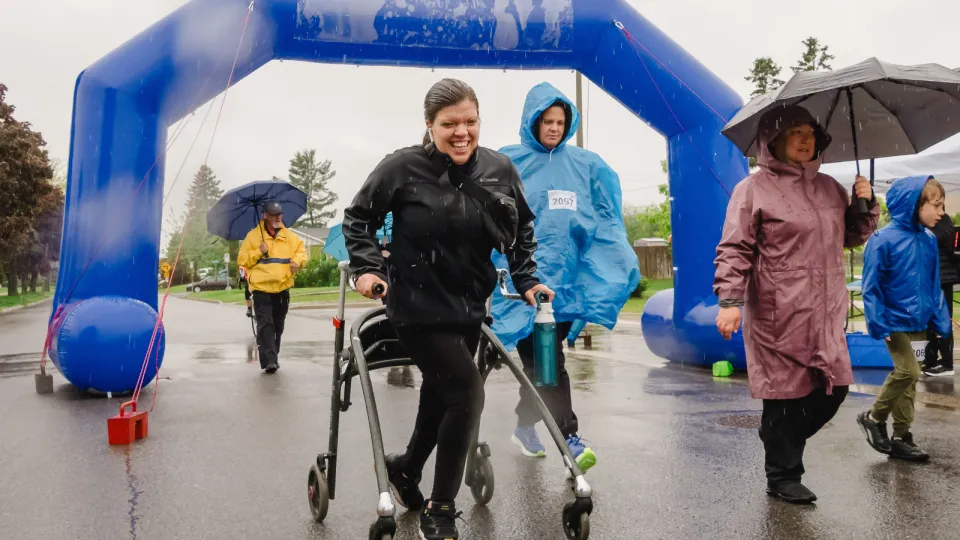 Woman using walking aid during Kilometres for Kids