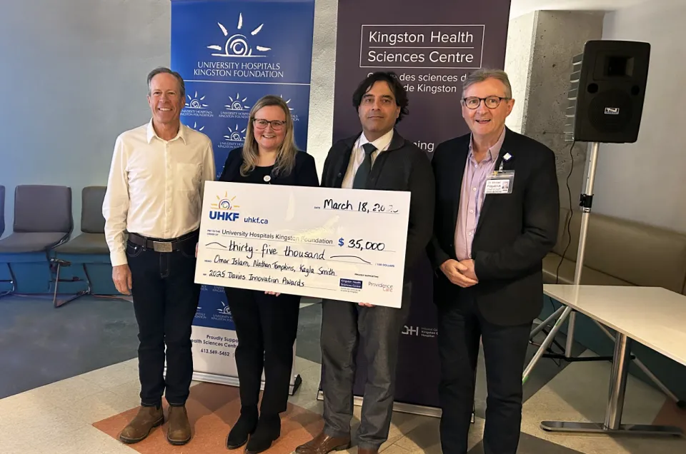 Dr Greg Davies, Kayla Smith, Dr Omar Islam Dr Michael Fitzpatrick holding a big cheque.