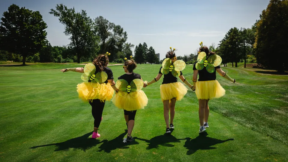 Golfers dressed up as bumble bees on the course at the Rose of Hope Golf Tournament.