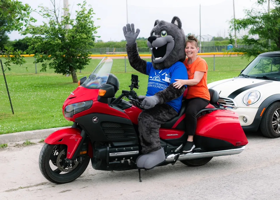 UHKF mascot Asher with Ride for Dad organizer Marion Perry