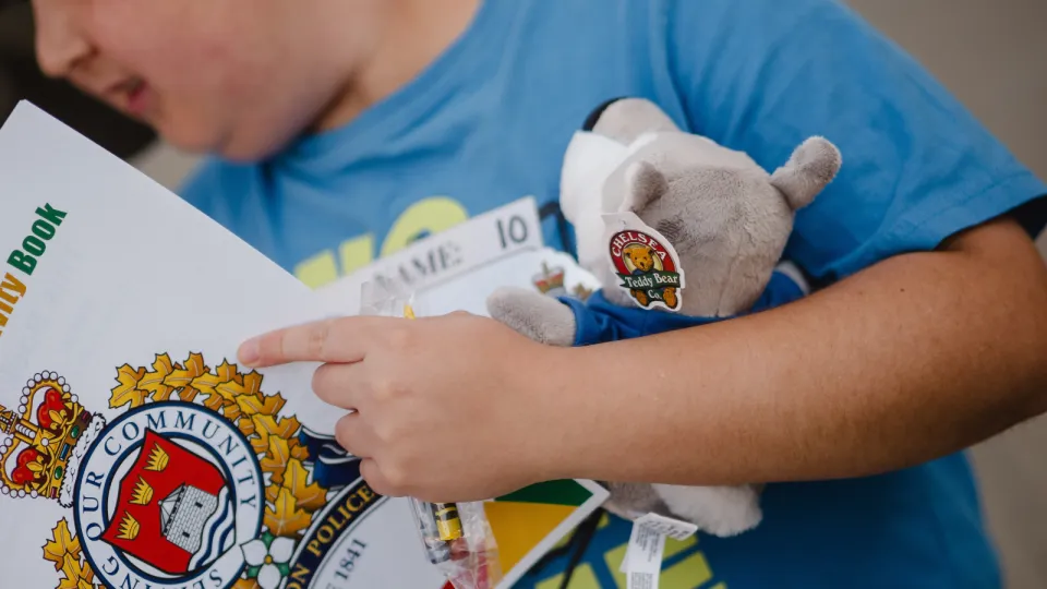 Child holding Asher doll