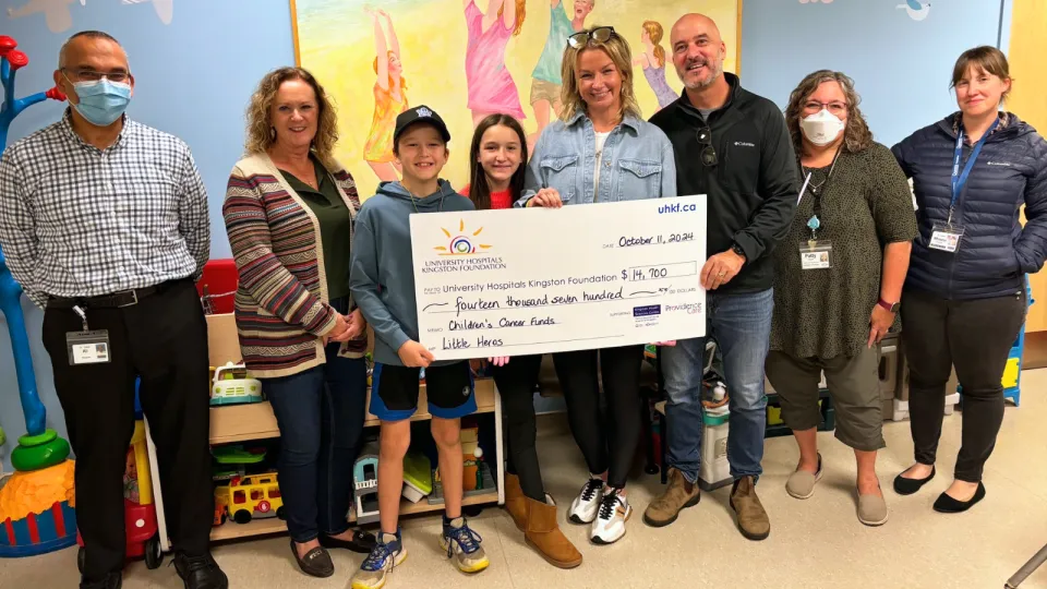 Little Heroes 2024 Cheque Presentation with family holding big cheque.