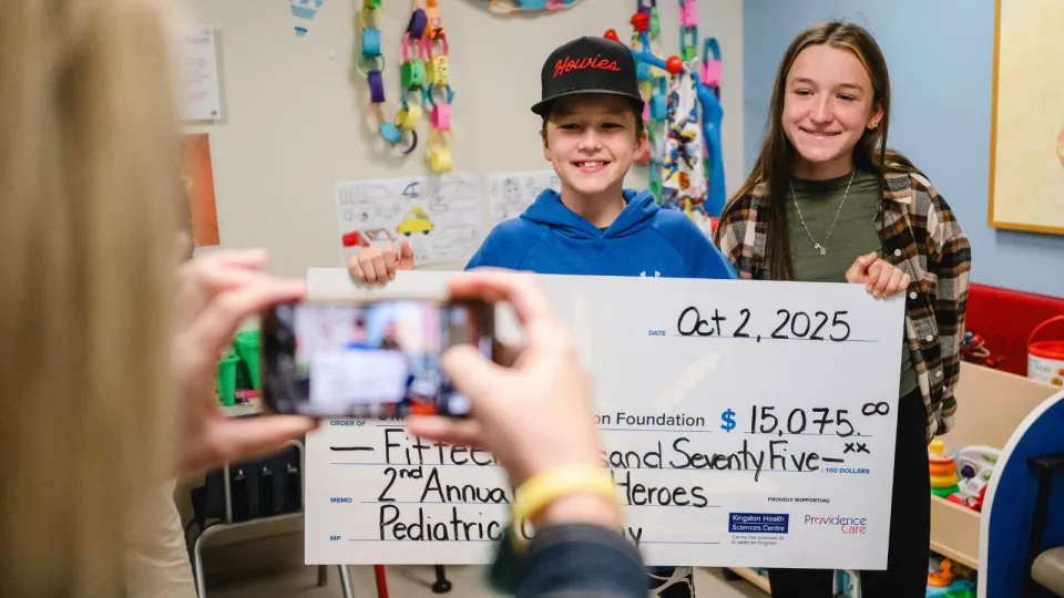 Little Heroes 2025 Cheque Presentation with kids holding big cheque.