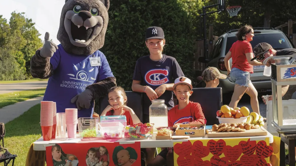 Carman family & friend at stand.