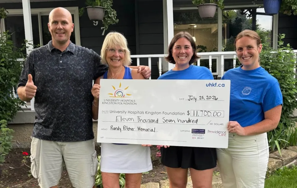 The Pitcher family holds a cheque for $11,700