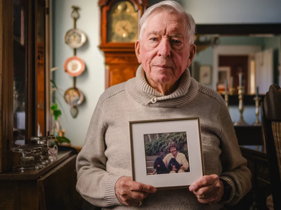 Dickson Mansfield holding a photo of his late wife Barbara