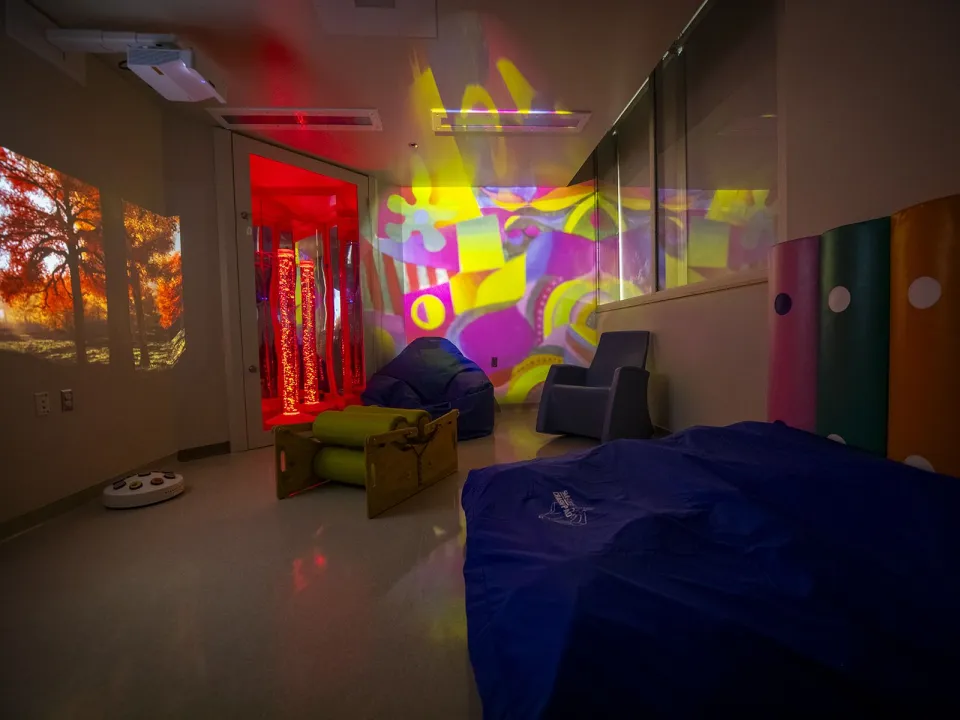 Image of the new multi-sensory room at Kingston Health Sciences Centre with calming lights and comfortable seating.