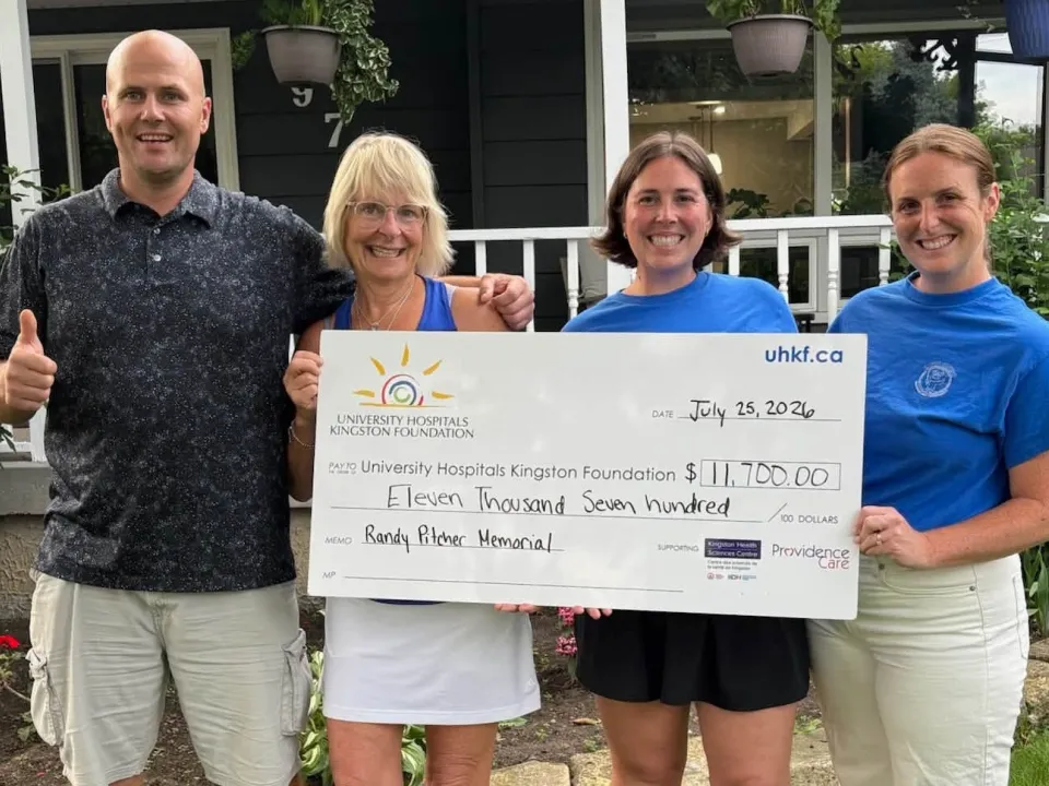 The Pitcher family holds a cheque for $11,700