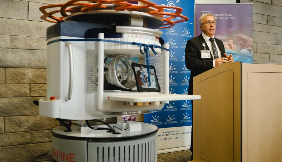 Dr. David Pichora standing next to the new portable MRI