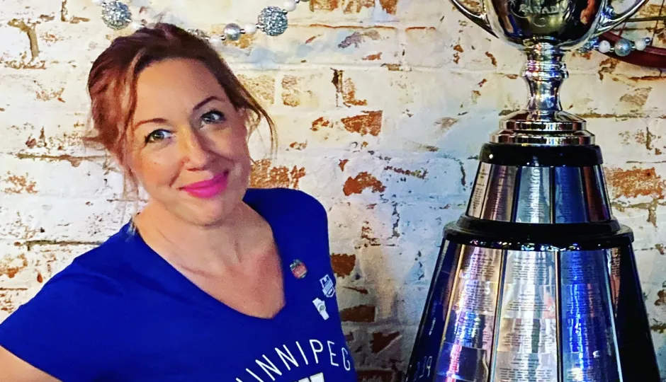 Kelly Hallett poses with the Grey Cup.