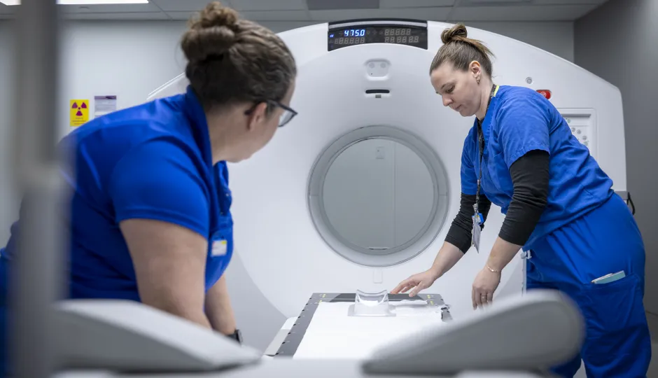KHSC staff setting up the PET-CT scanner.