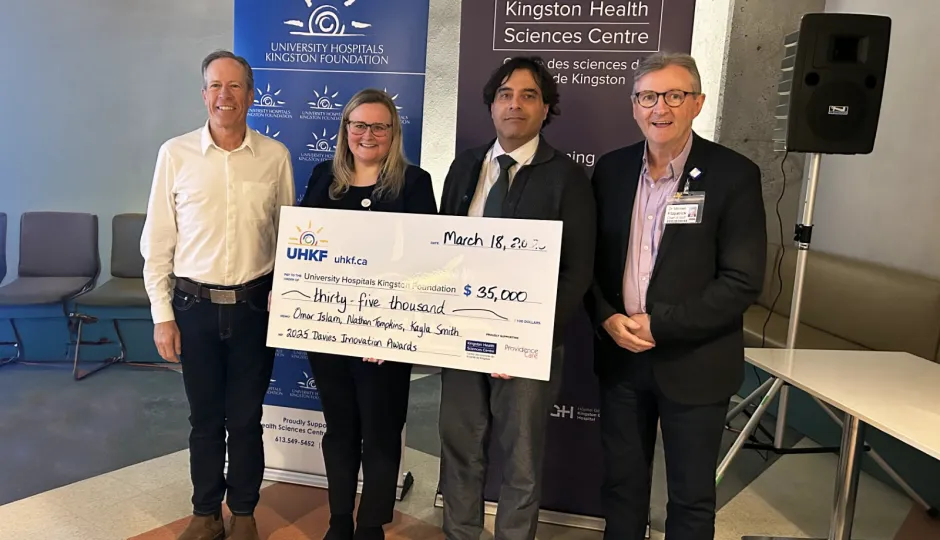 Dr Greg Davies, Kayla Smith, Dr Omar Islam Dr Michael Fitzpatrick holding a big cheque.