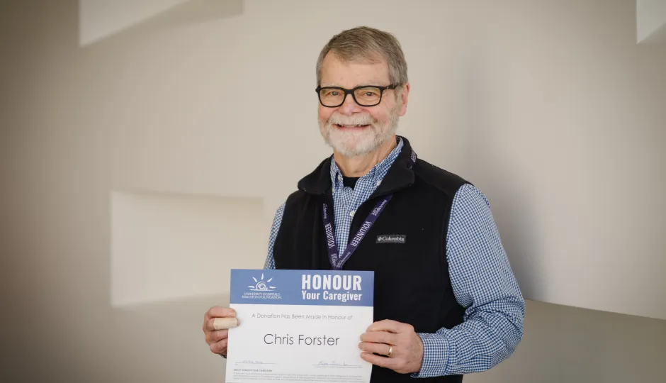 Chris Forster holds his Honour Your Caregiver award