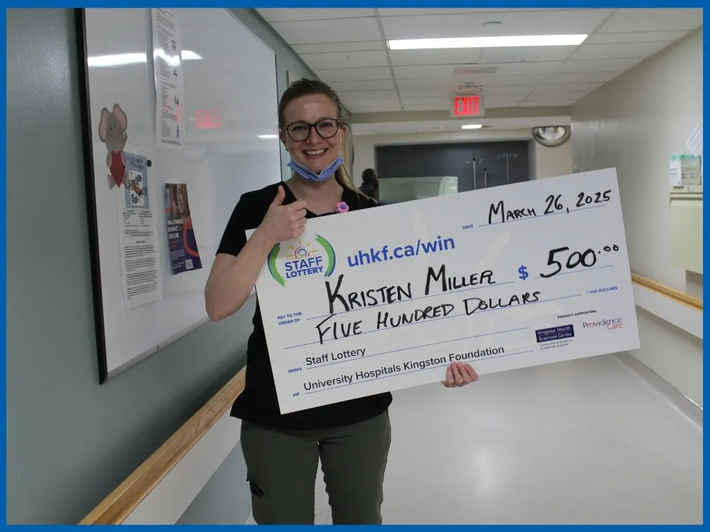 Kristen Miller holding $500 chq. at KHSC