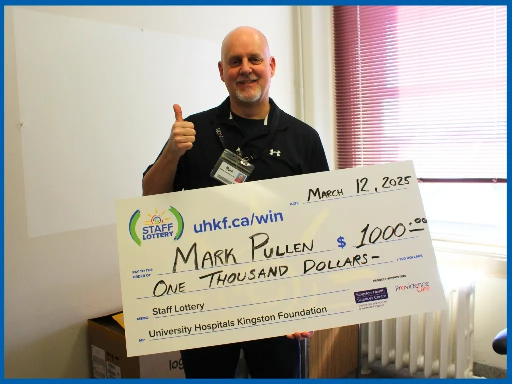 Mark Pullen holding $1000 chq March 12