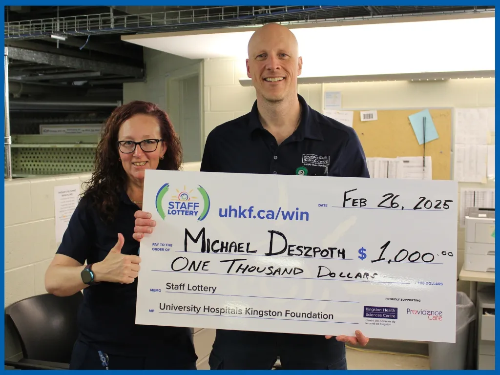 Mike D holding his $1000 winning Chq March 12/25