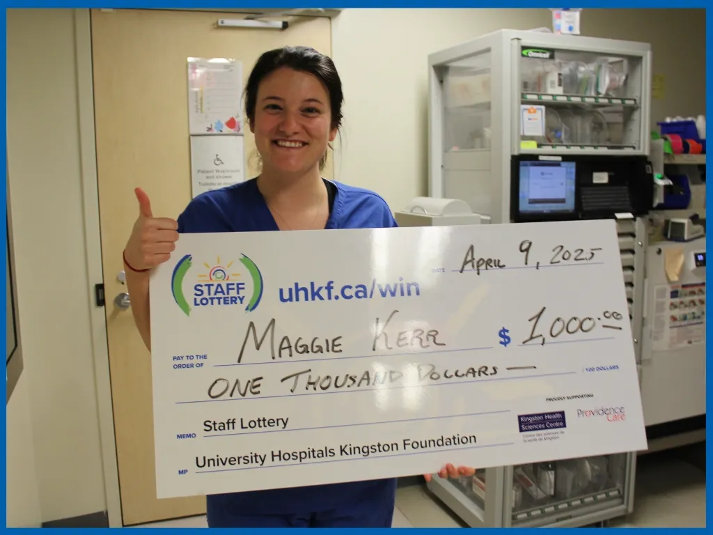 Maggie Kerr holding $1000 chq