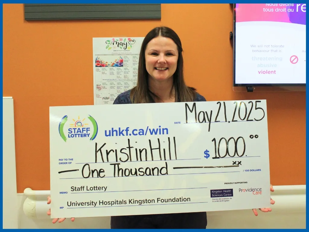 Kristin Hill holding large cheque.