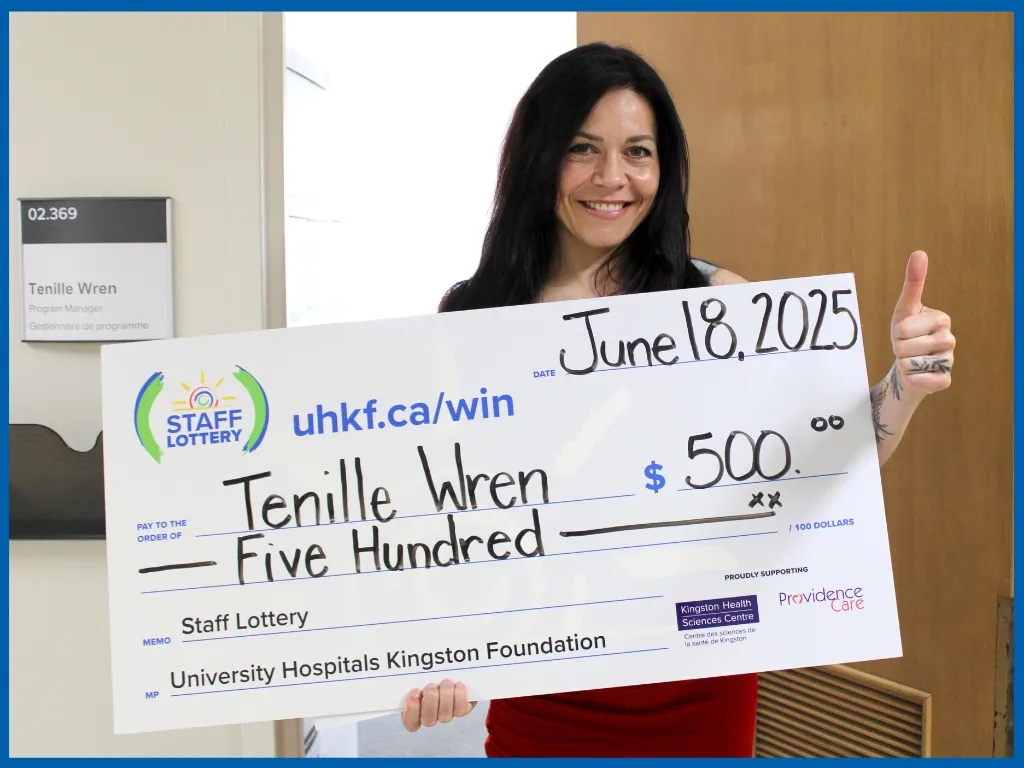 Tenille Wren holding large cheque.