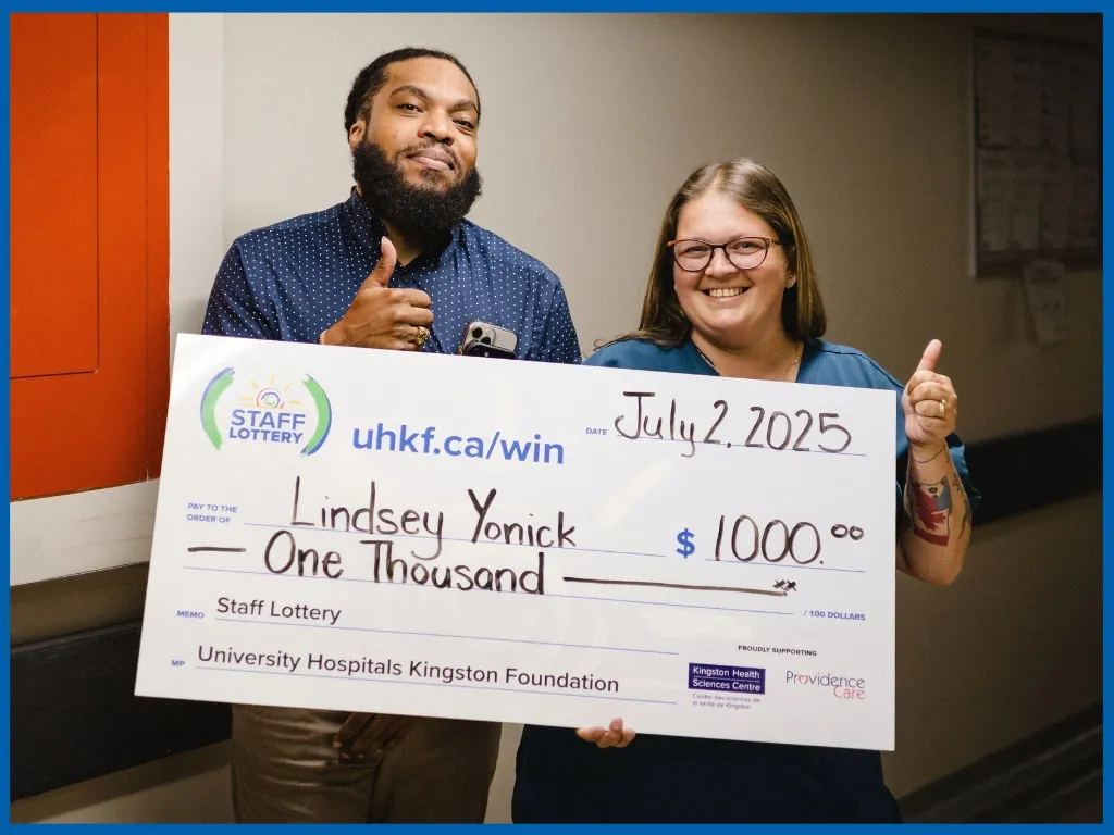 Lindsey Yonick holding large cheque.