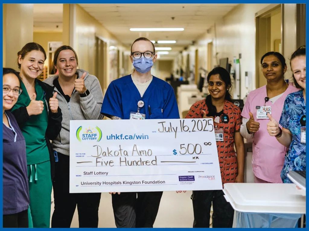 Dakota Amo holding large cheque.
