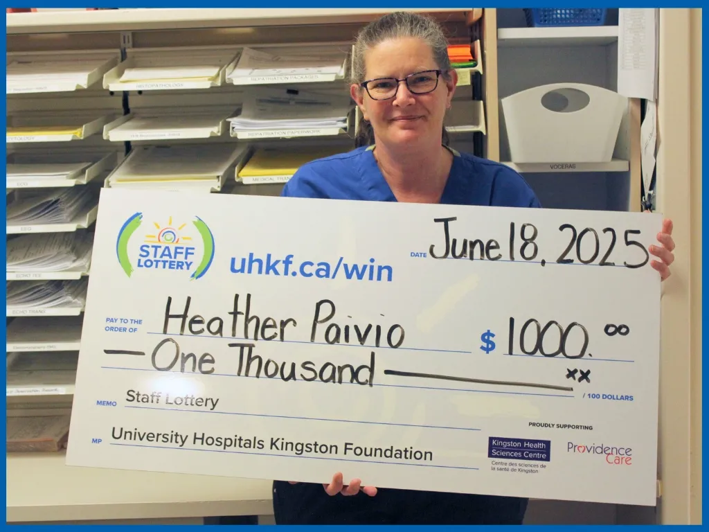 Heather Paivio holding large cheque.