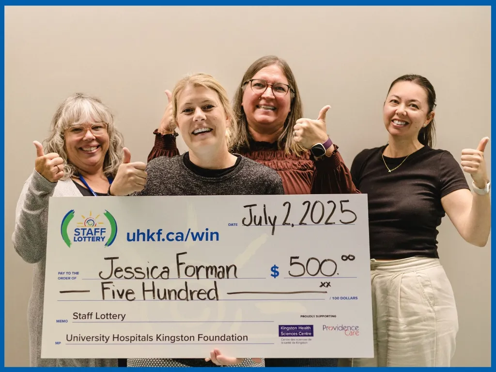 Jessica Forman holding large cheque.