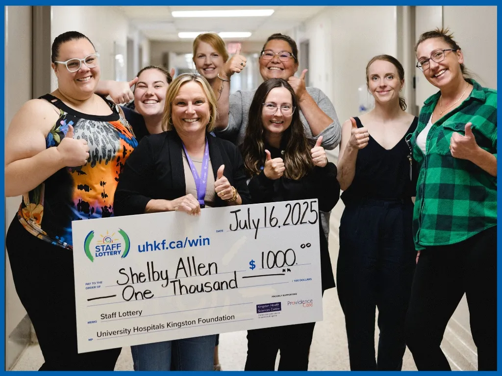 Shelby Allen holding large cheque.