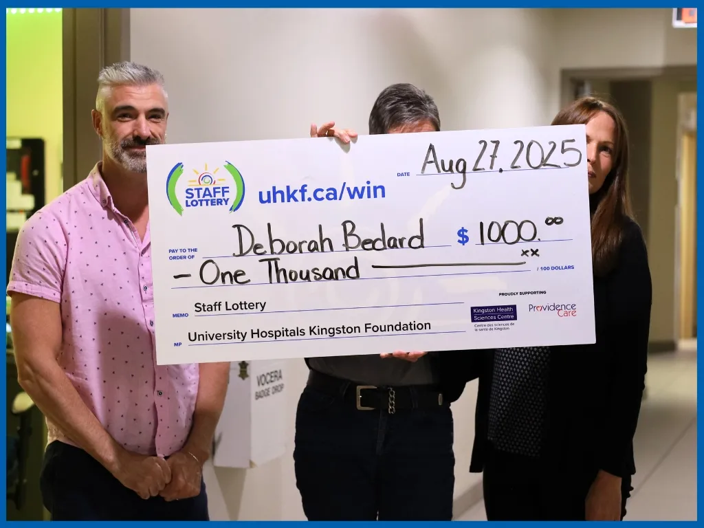 Deborah Bedard holding large cheque. 