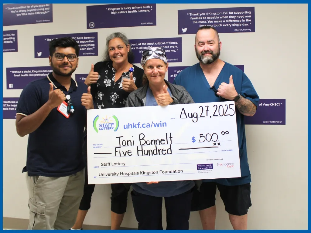 Toni Bonnett holding large cheque.