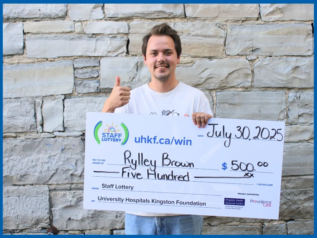 Rylley Brown holding large cheque.