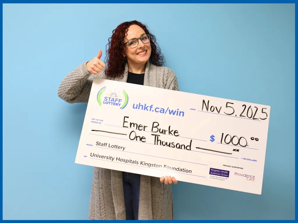 Emer Burke holding large cheque.