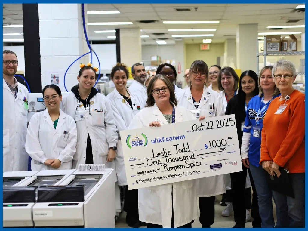 Leslie Todd holding large cheque.
