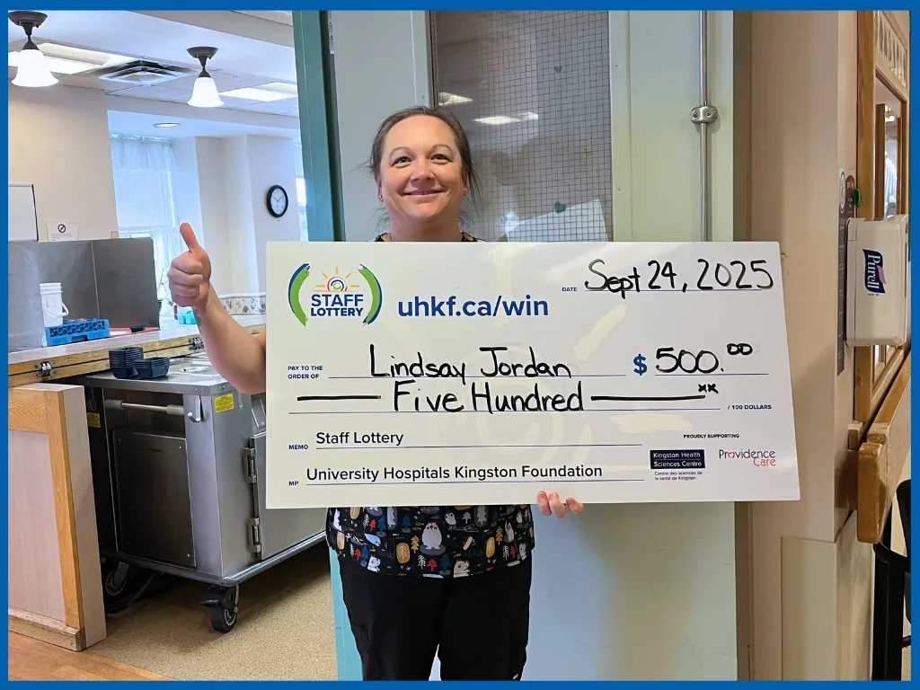 Lindsey Jordan holding large cheque.