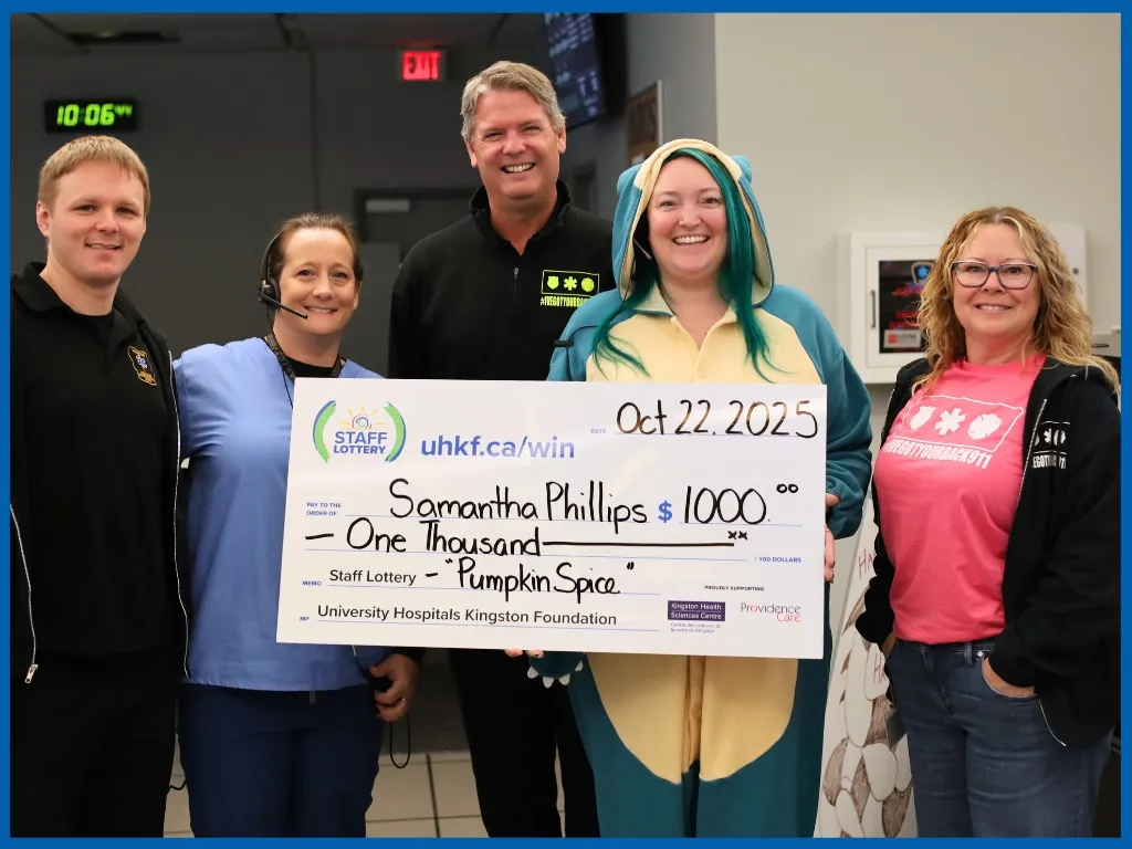 Samantha Phillips holding large cheque.